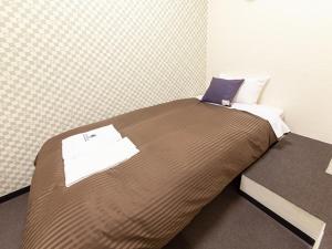 Postel nebo postele na pokoji v ubytování HOTEL LiVEMAX BUDGET Nippori