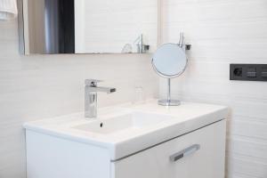 a bathroom with a white sink and a mirror at Apartamento Alma in Puerto del Carmen +12 photos