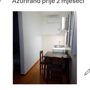 a kitchen with a table and chairs and a sink at 2 Apartm for rent in Korcula in Korčula