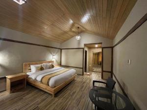 a bedroom with a bed and a chair in it at Dream Nest Resort in Skardu