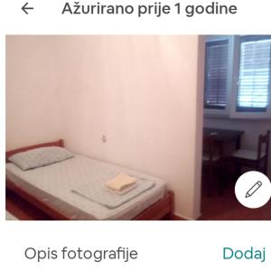 a small bedroom with a bed and a table at inKorcula in Korčula