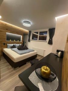 a bedroom with a bed and a table at Activ-Family-Apart-Wisiol-Pitztal Sommercard inklusive in Jerzens