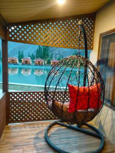 a bird cage sitting on top of a porch at Dream Nest Resort in Skardu