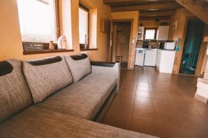 a living room with a couch and a kitchen at Chata Alex Liptov in Trstené