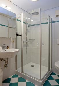 a bathroom with a glass shower and a sink at Ferienhaus Mitterdorf in Mitterfirmiansreut