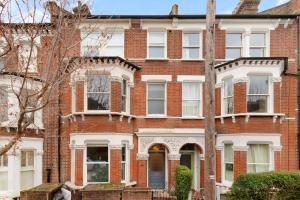 an old brick building with white windows at 1 bed Clapham Junction apartment in London