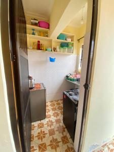 a small kitchen with a sink and a stove at Happy home in Arusha