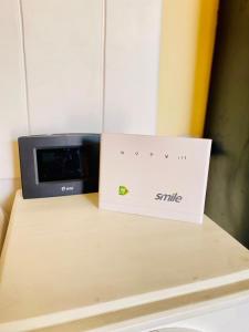 a box sitting on a table next to a microwave at Happy home in Arusha