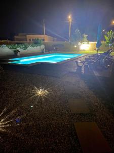 een leeg zwembad met verlichting bij 2 bedrooms house with enclosed garden and wifi at Ponte de Vagos in Ponte de Vagos