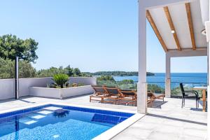 a villa with a swimming pool and a patio at Villa Blue Panorama in Vela Luka