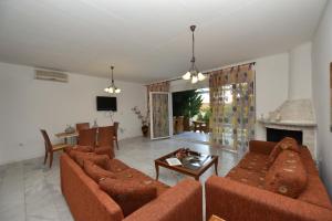 a living room with two couches and a fireplace at Olympic Kosmas Villas in Hanioti
