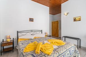 A bed or beds in a room at Apollon Rooms