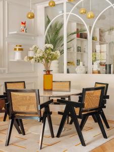 a dining room with a table and chairs at Solly Hôtel Paris in Paris