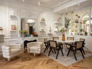 a dining room with a table and chairs and a fireplace at Solly Hôtel Paris in Paris