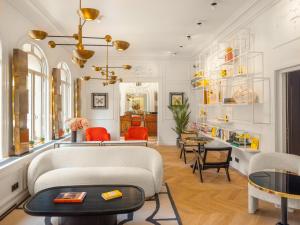 a living room with a couch and a table at Solly Hôtel Paris in Paris
