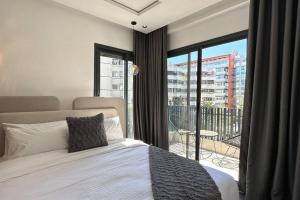 a bedroom with a bed and a large window at Sunny 2 Bedrooms - By AppartAli in Casablanca