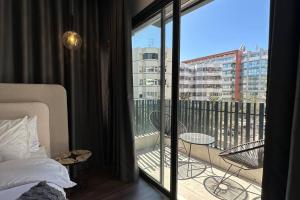 a bedroom with a bed and a balcony with a view at Sunny 2 Bedrooms - By AppartAli in Casablanca