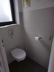 a small bathroom with a toilet and a window at ANGLET petite Maison à 2 kms des plages et de Biarritz in Anglet