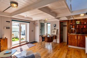 a living room with a table and a window at Finest Retreats - The Watchtower at Western Watch in Lower Boscaswell