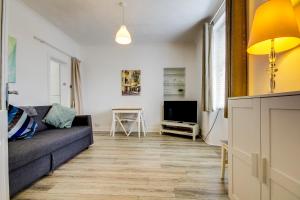 a living room with a couch and a tv at Apartment Caerlaverock Road in Prestwick