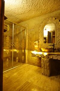 a bathroom with a mirror and a sink and a mirror at Nova Cave Hotel in Ortahisar