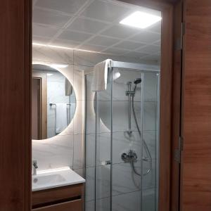 a bathroom with a glass shower and a sink at Dab Hotel Ulus in Ankara