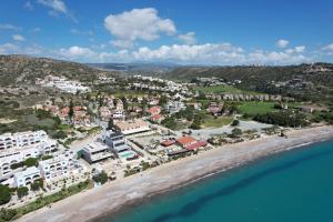 an aerial view of a beach and buildings at Pissouri bay studio in Pissouri