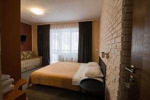 a hotel room with a bed and a window at SKI Xata in Bukovel