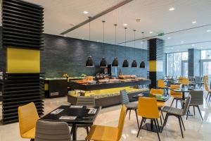 a restaurant with tables and chairs and a buffet at HF Fenix Music in Lisbon