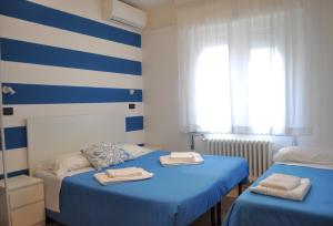 Postel nebo postele na pokoji v ubytování Hotel Susy - Ambienti rinnovati - direttamente su viale Dante e a due passi dal mare