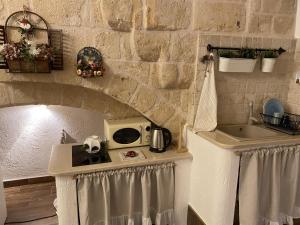 a kitchen with a sink and a microwave on a counter at Casa Rebecca 14 in Monopoli +37 photos