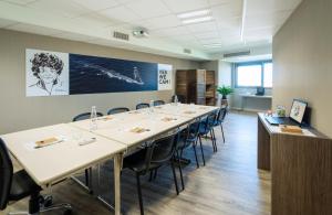 a large conference room with a long table and chairs at ibis Styles Les Sables Olonne in Les Sables-d'Olonne
