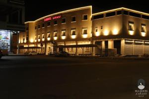 a large building with lights in front of it at سي مون قمر البحر in Yanbu