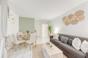 a living room with a couch and a table at Green place Disneyland Paris in Bussy-Saint-Georges