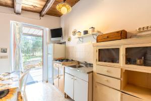 a kitchen with a sink and a stove at Villa Nzina in Castellammare del Golfo