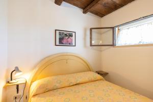 a bedroom with a bed and a window at Villa Nzina in Castellammare del Golfo