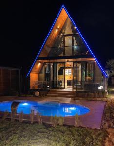 a house with a pool in front of it at night at 7Sense Nature Resort in Sapanca