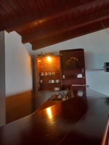 a kitchen with a wooden table and a sink at Villa Renesans in Star Dojran