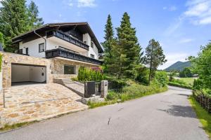 a house with a garage on the side of a road at Villa Chou Chou in Steinhaus am Semmering