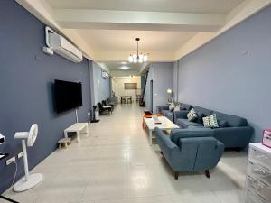 sala de estar con paredes azules y sofá azul en 花漾四季民宿市中心附停車位 自助入住 可包棟, en Hualien City