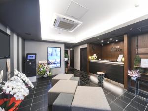 a salon with a waiting room with benches and flowers at HOTEL LiVEMAX Asakusa-Ekimae in Tokyo