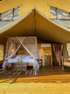 a bed in a tent in a room at TERRA - Saturnia tented lodges in Saturnia