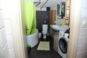 a bathroom with a tub and a sink and a washing machine at WOODEN HOUSE in Preveza +36 photos