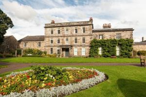 an old house with a garden in front of it at Hexham House Penthouse Apartment Seven in Hexham