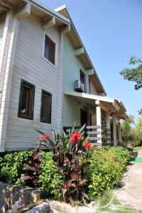 a house with red flowers in front of it at WOODEN HOUSE in Preveza