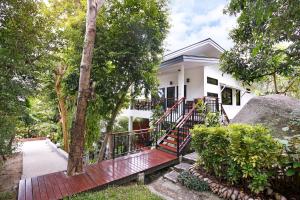 a white house with a red deck in front of it at 2 Bays Villa in Thong Nai Pan Yai