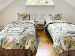 a bedroom with two beds and a window at Holiday home RONNEBY X in Ronneby