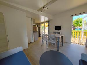 a kitchen and dining room with a table and chairs at Camping Rio Nela in Trespaderne