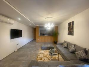 - un salon avec un canapé et une télévision dans l'établissement Marrakchia apartment Guéliz, à Marrakech