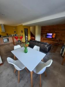 a living room with a white table and chairs at Pacha Home By A.M.A in San Carlos de Bariloche